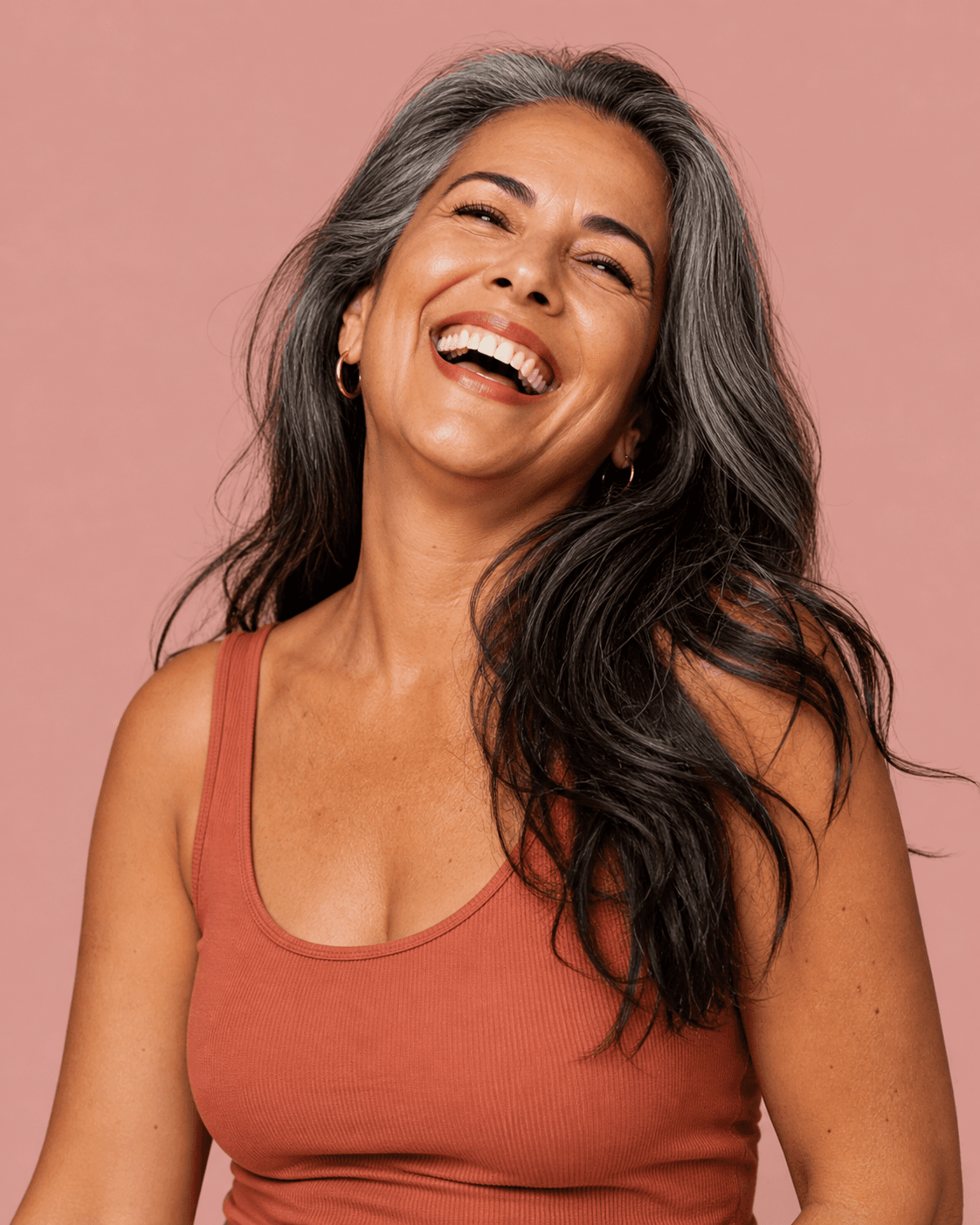 A joyful woman, mid-laugh — because honest cost conversations should feel less stressful, not more.