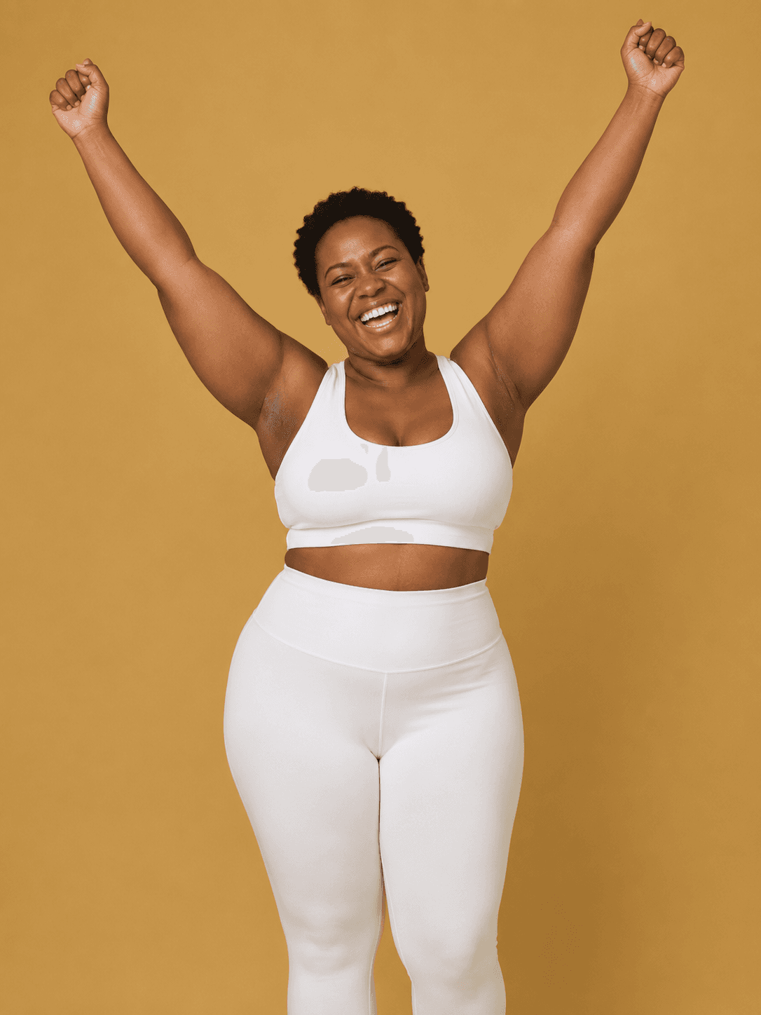 A woman with her arms raised in joy — the energy of taking your health into your own hands.